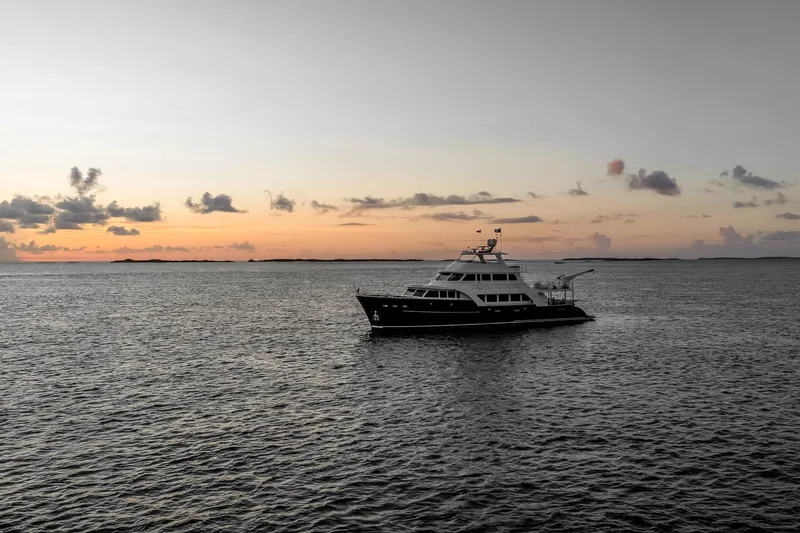 Top Times Yacht Photos Pics Marlow Voyager Series 2022 yacht at sunset on calm ocean waters.