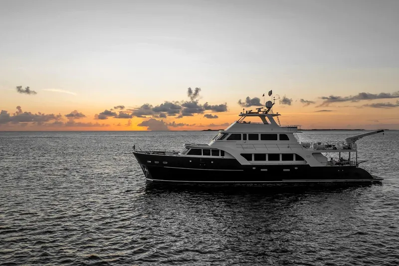 Top Times Yacht Photos Pics Luxury Marlow Voyager Series yacht at sunset, 2022 model, cruising on open sea.