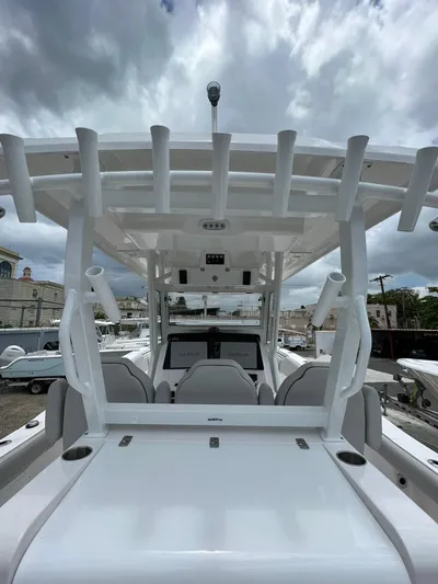  Yacht Photos Pics 2023 Sea Fox 328 Commander boat with rod holders, sleek design, and overcast sky background.