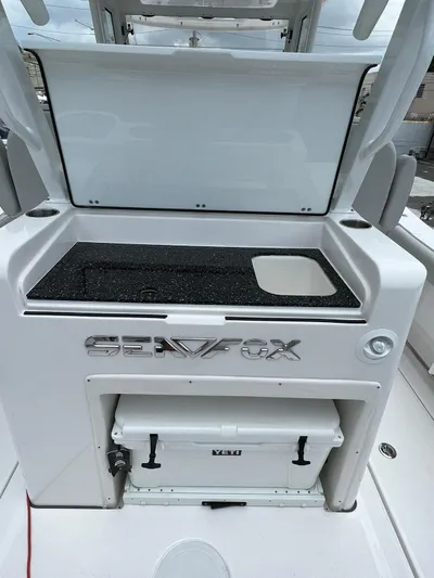  Yacht Photos Pics 2023 Sea Fox 328 Commander boat interior with storage and cooler compartment.