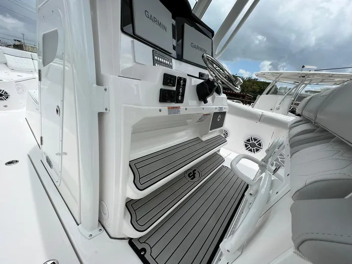  Yacht Photos Pics 2023 Sea Fox 328 Commander boat interior with Garmin displays and sleek seating.