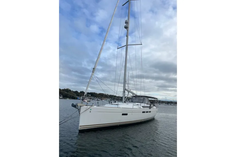  Yacht Photos Pics 2012 Jeanneau Sun Odyssey 509 sailboat on calm water under cloudy sky.