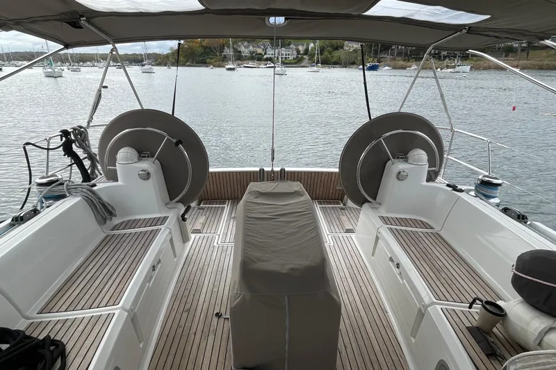  Yacht Photos Pics Cockpit view of 2012 Jeanneau Sun Odyssey 509 sailboat with scenic harbor background.