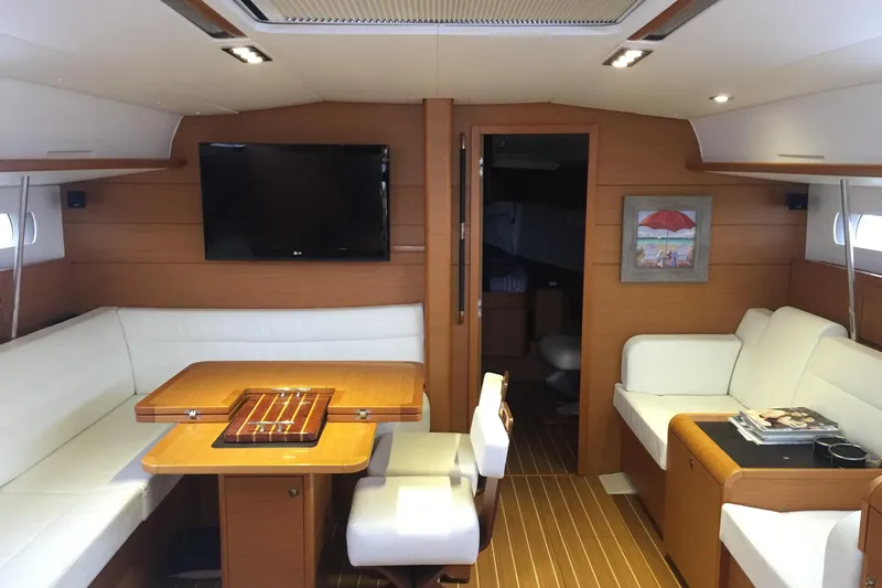  Yacht Photos Pics Interior of 2012 Jeanneau Sun Odyssey 509 yacht with elegant seating and wooden finishes.