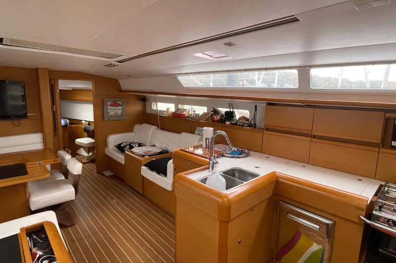  Yacht Photos Pics Interior of 2012 Jeanneau Sun Odyssey 509 yacht, featuring modern kitchen and cozy seating area.