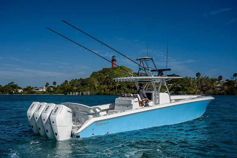 T/t Waterfront Yacht Photos Pics 2013 Bahama Quad V10's boat on water with lighthouse in background.