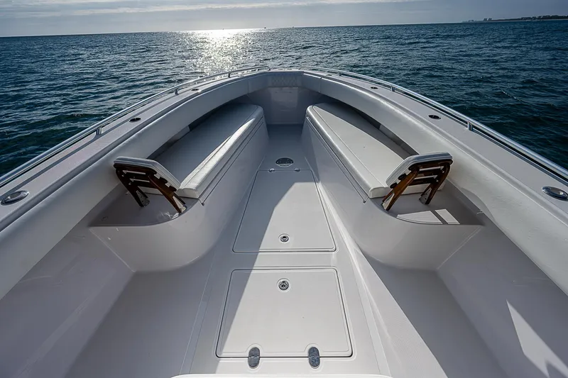 T/t Waterfront Yacht Photos Pics 2013 Bahama Quad V10's boat deck with seating, overlooking the ocean at sunset.