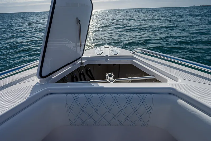 T/t Waterfront Yacht Photos Pics 2013 Bahama Quad V10's boat with open storage compartment on calm ocean.