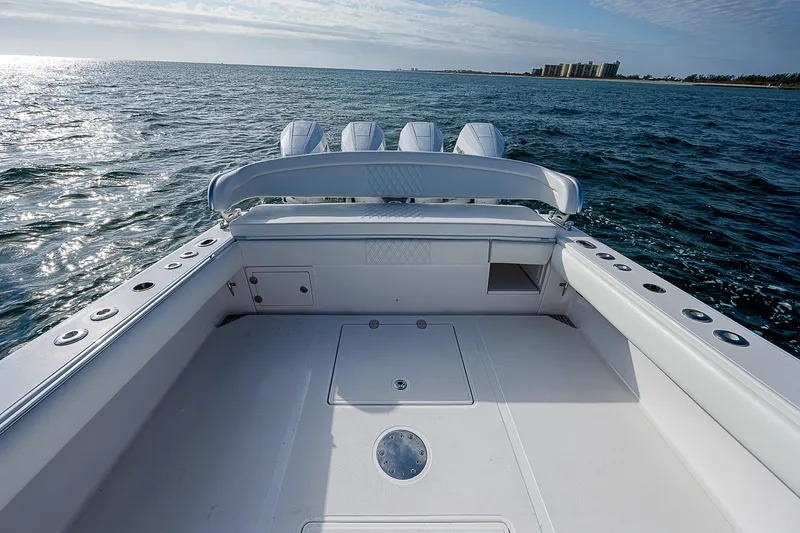 T/t Waterfront Yacht Photos Pics 2013 Bahama Quad V10's boat deck on open water, clear sky, and distant shoreline.