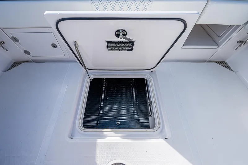 T/t Waterfront Yacht Photos Pics Open hatch on 2013 Bahama Quad V10's boat deck, showcasing storage compartment.