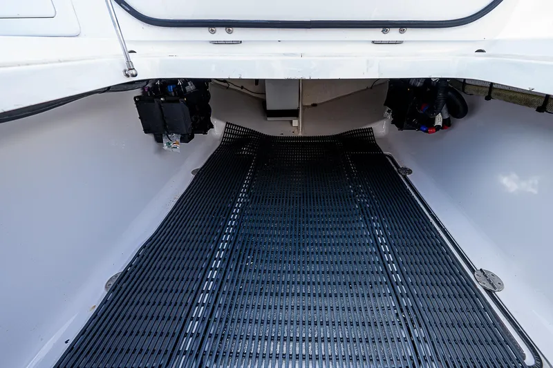 T/t Waterfront Yacht Photos Pics 2013 Bahama Quad V10's boat interior with black flooring and storage compartments.