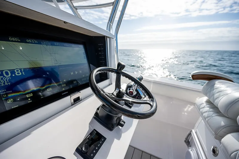 T/t Waterfront Yacht Photos Pics Steering console of 2013 Bahama Quad V10's boat with ocean view.