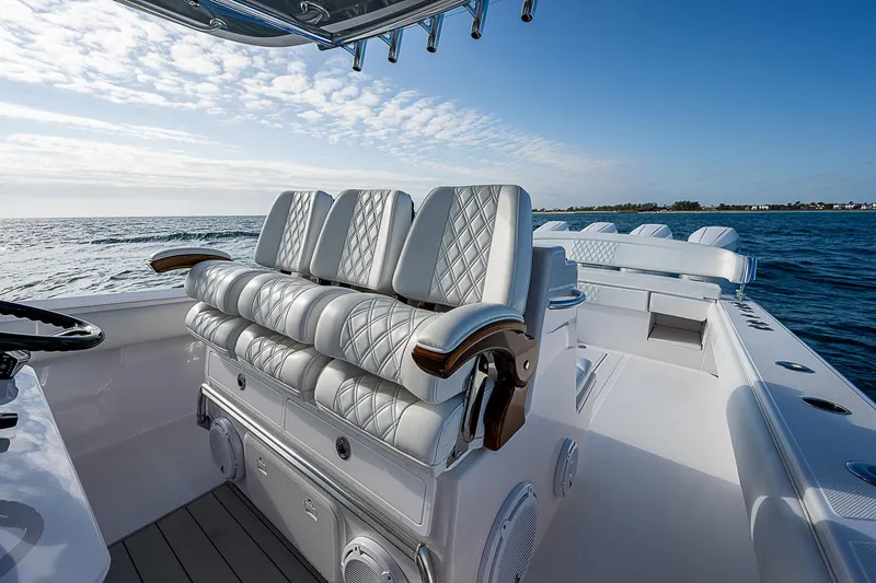 T/t Waterfront Yacht Photos Pics Luxurious 2013 Bahama Quad V10's boat interior with plush seating on open water.
