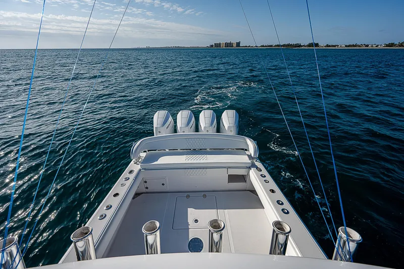 T/t Waterfront Yacht Photos Pics Bahama Quad V10's 2013 boat cruising on open water, clear sky, and distant shoreline.