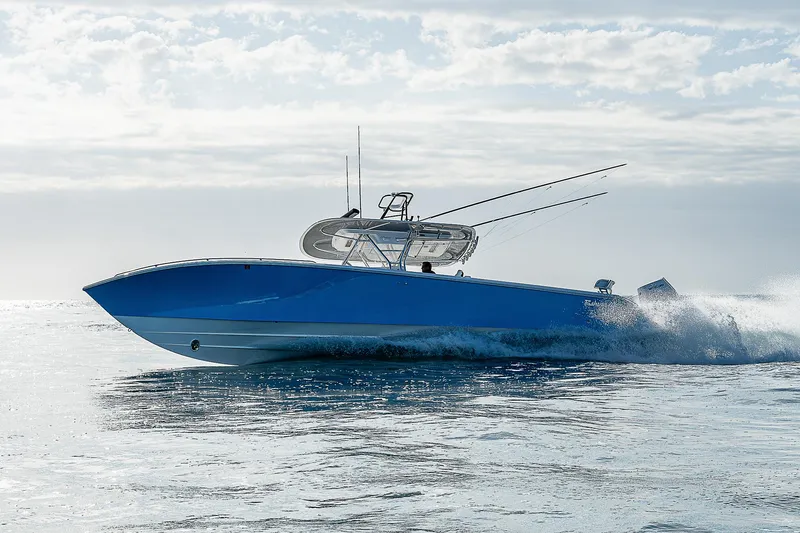 T/t Waterfront Yacht Photos Pics 2013 Bahama Quad V10's speedboat cruising on open water under a cloudy sky.