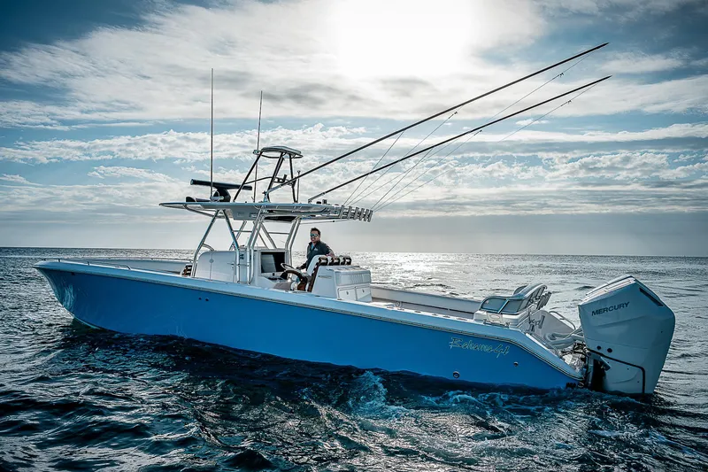 T/t Waterfront Yacht Photos Pics 2013 Bahama Quad V10's boat cruising on open ocean under a cloudy sky.