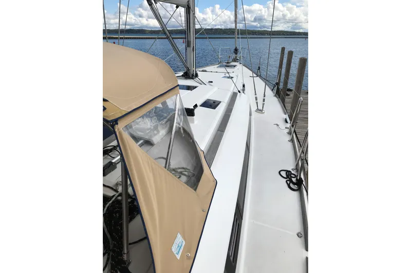 Northern Lights Yacht Photos Pics 2015 Jeanneau Sun Odyssey 469 sailboat docked, featuring a beige canopy and sleek deck design.