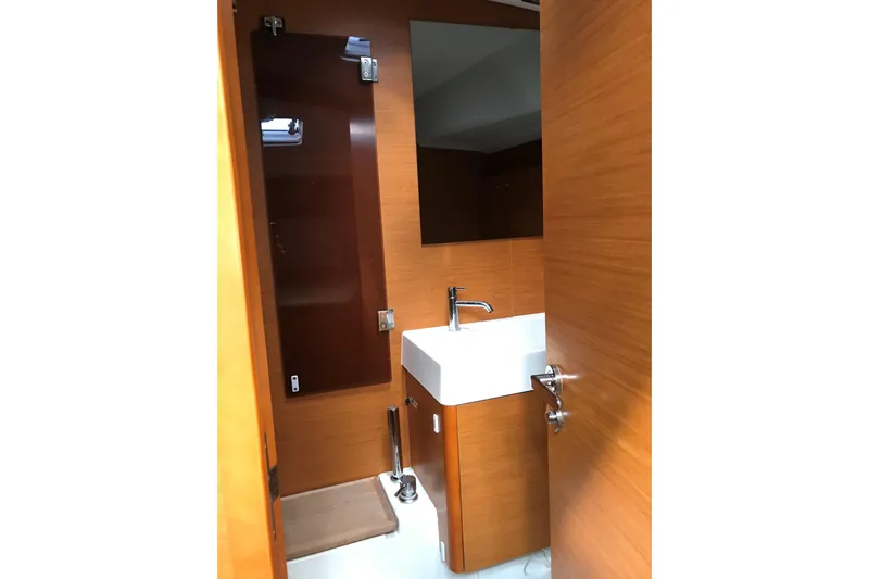 Northern Lights Yacht Photos Pics Bathroom interior of 2015 Jeanneau Sun Odyssey 469 yacht with wooden finish and modern sink.