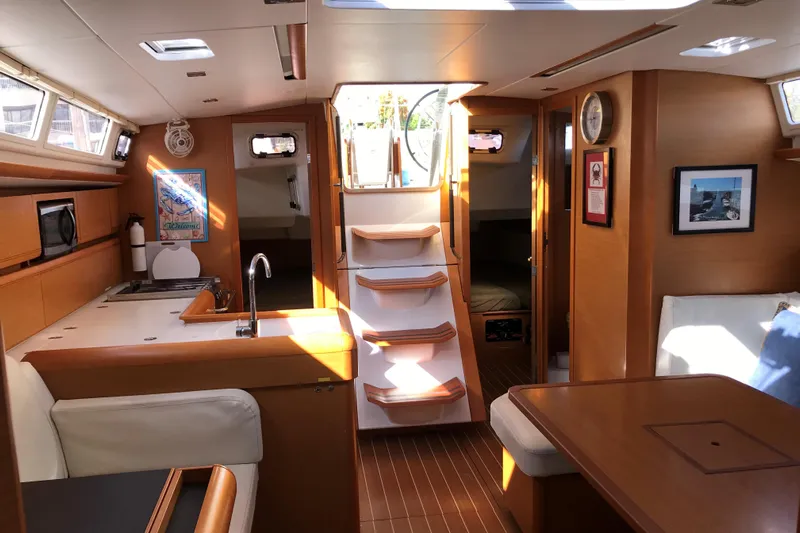 Northern Lights Yacht Photos Pics Interior of 2015 Jeanneau Sun Odyssey 469 sailboat, featuring kitchen and seating area.