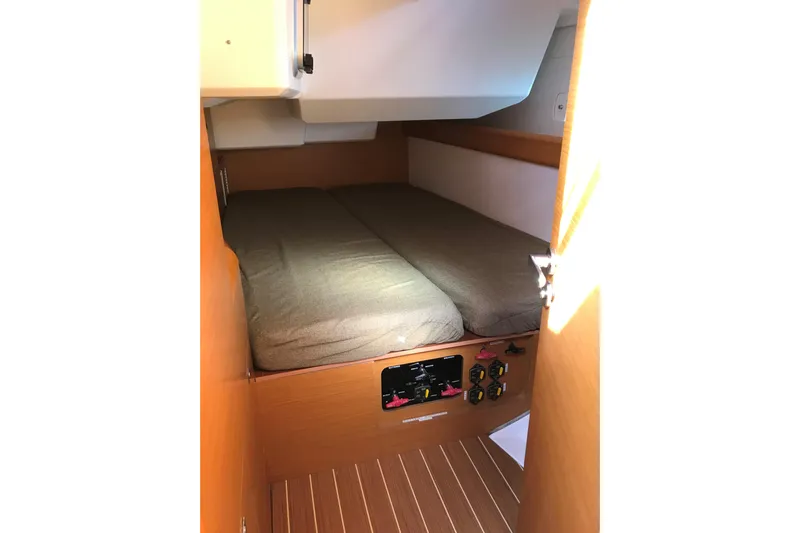 Northern Lights Yacht Photos Pics Cabin interior of 2015 Jeanneau Sun Odyssey 469 sailboat with cozy bed and control panel.