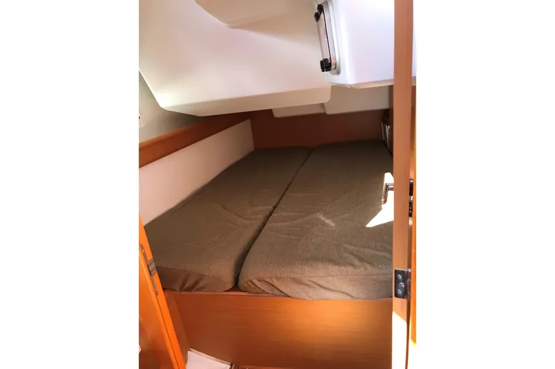 Northern Lights Yacht Photos Pics Cabin interior of 2015 Jeanneau Sun Odyssey 469 sailboat with cozy bedding.