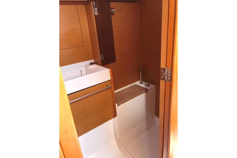 Northern Lights Yacht Photos Pics 2015 Jeanneau Sun Odyssey 469 bathroom interior with wooden cabinetry and compact sink.