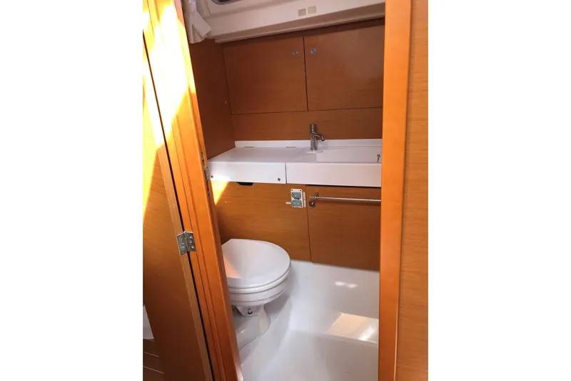 Northern Lights Yacht Photos Pics Interior of 2015 Jeanneau Sun Odyssey 469 yacht bathroom with wooden cabinetry and modern fixtures.