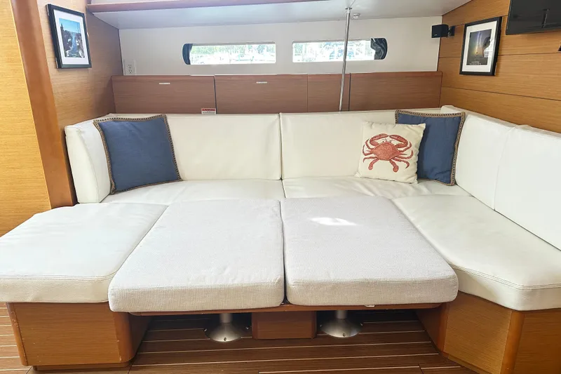 Northern Lights Yacht Photos Pics Interior of 2015 Jeanneau Sun Odyssey 469 yacht with white seating and nautical decor.