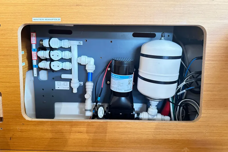Northern Lights Yacht Photos Pics Water manifold system in 2015 Jeanneau Sun Odyssey 469 yacht, featuring pipes and pressure tank.