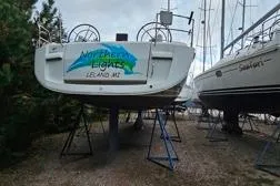 Northern Lights Yacht Photos Pics 2015 Jeanneau Sun Odyssey 469 sailboat on stands, displayed outdoors.