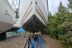 Northern Lights Yacht Photos Pics 2015 Jeanneau Sun Odyssey 469 sailboat on stands, surrounded by trees.