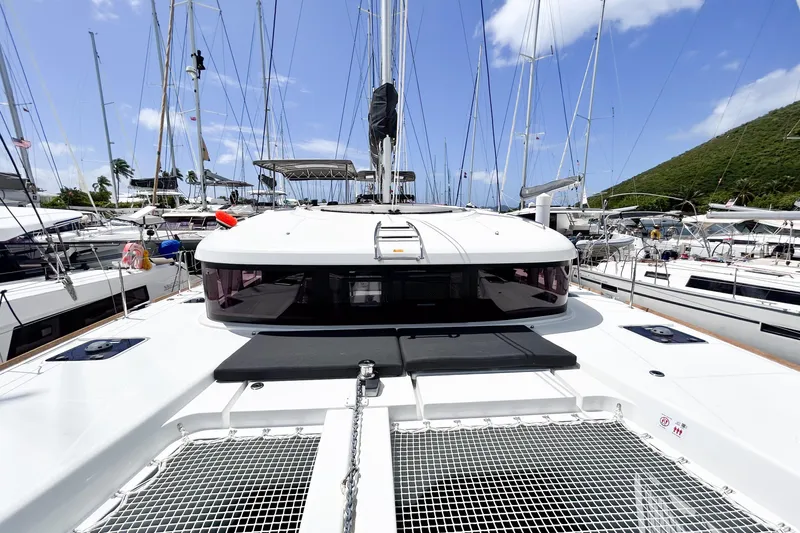 Oasis Yacht Photos Pics 2025 Lagoon 40 catamaran docked at marina, showcasing sleek design and spacious deck.