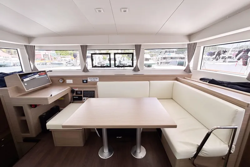 Oasis Yacht Photos Pics Interior of 2025 Lagoon 40 catamaran with modern seating and navigation area.