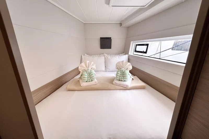 Oasis Yacht Photos Pics Luxurious cabin interior of 2025 Lagoon 40 yacht with neatly arranged towels.