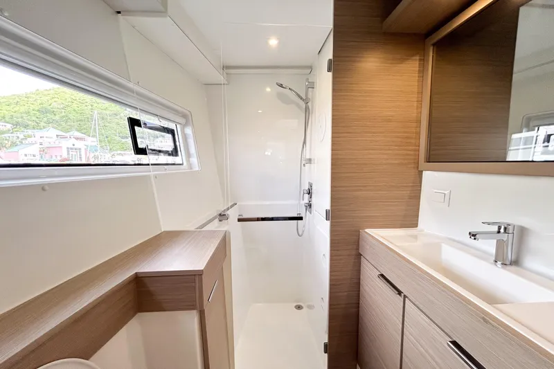 Oasis Yacht Photos Pics Modern bathroom in 2025 Lagoon 40 yacht with sleek fixtures and wood accents.