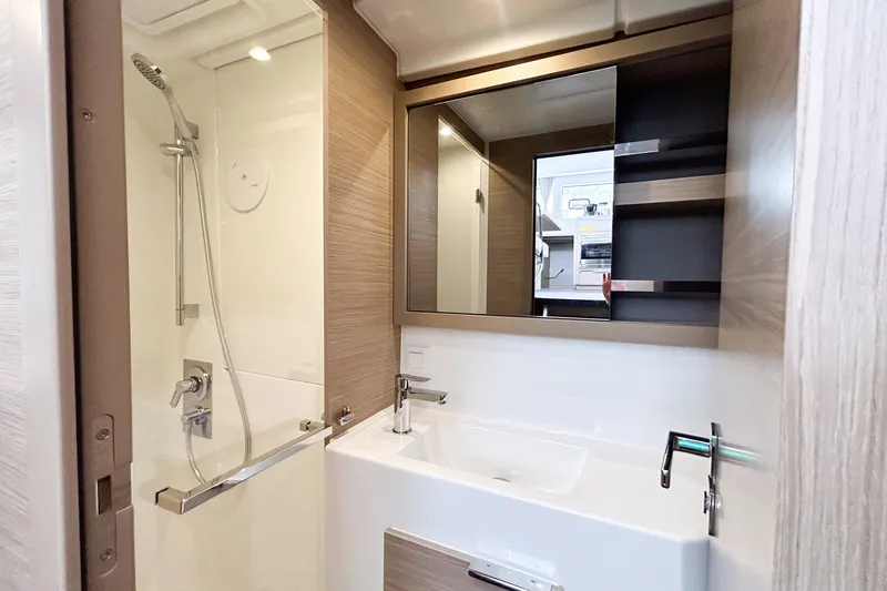 Oasis Yacht Photos Pics Modern bathroom in 2025 Lagoon 40 yacht with shower and sleek vanity.
