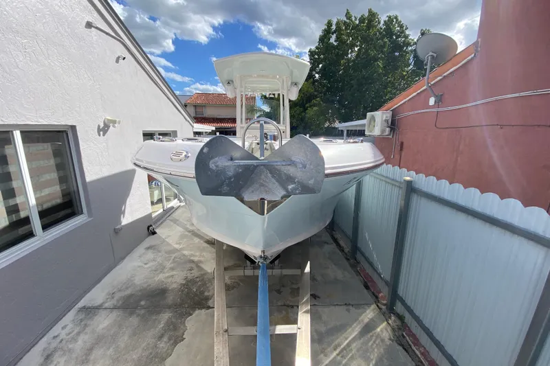  Yacht Photos Pics 2018 Robalo R242 Center Console boat on a lift, outdoor setting.