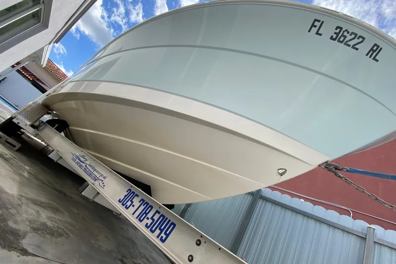 Yacht Photos Pics 2018 Robalo R242 Center Console boat on trailer, viewed from below.