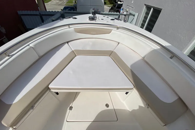  Yacht Photos Pics 2018 Robalo R242 Center Console boat with spacious seating and table in bow area.