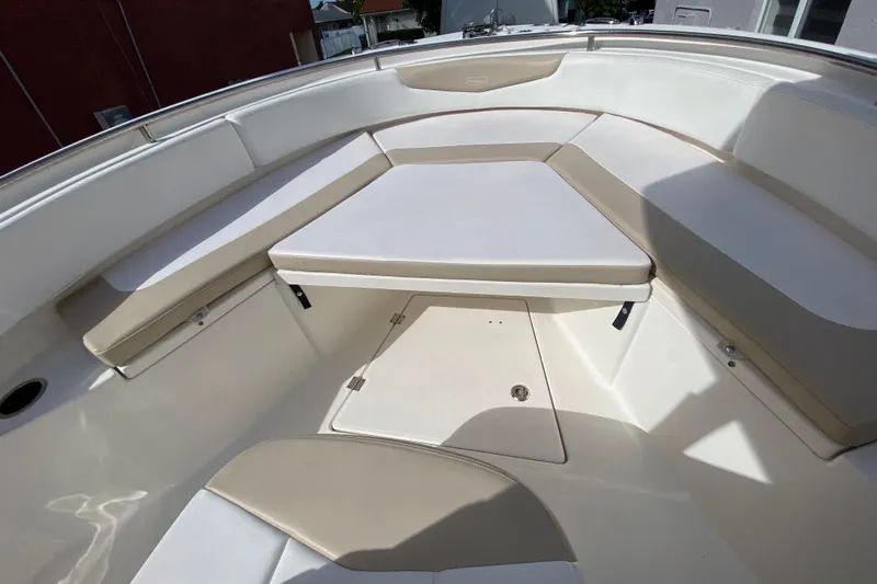  Yacht Photos Pics 2018 Robalo R242 Center Console boat interior with cushioned seating and storage.