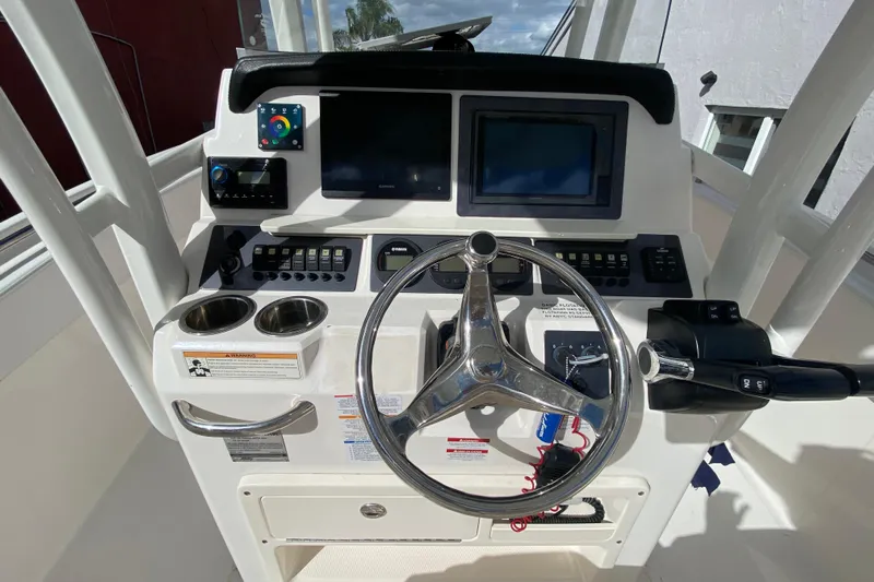  Yacht Photos Pics 2018 Robalo R242 Center Console boat dashboard with steering wheel and controls.