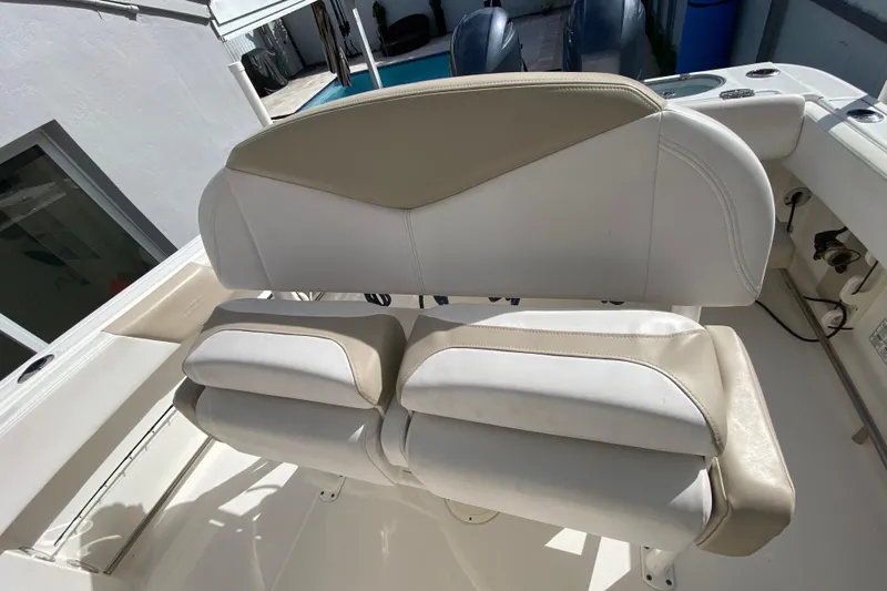  Yacht Photos Pics 2018 Robalo R242 Center Console boat seating area with beige and white upholstery.