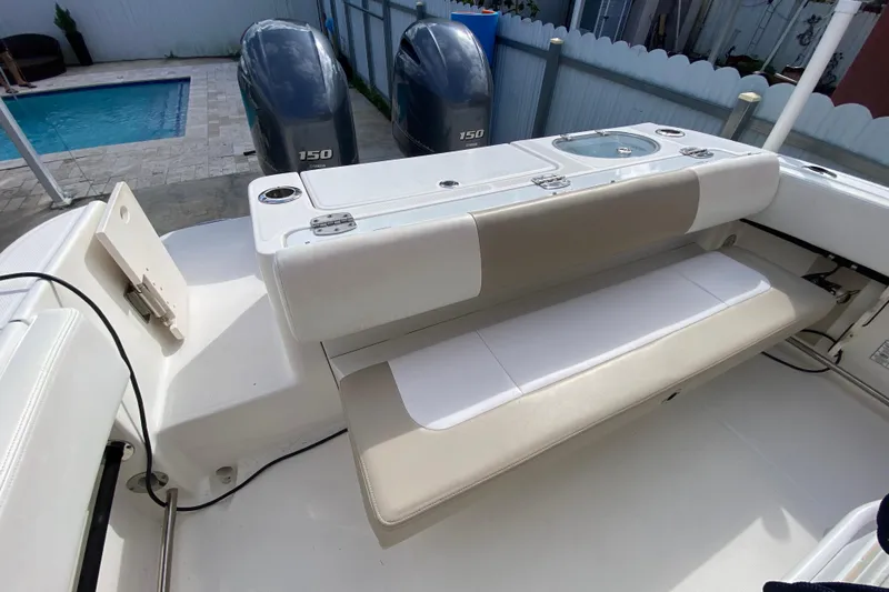  Yacht Photos Pics 2018 Robalo R242 Center Console boat with dual 150 engines, near a poolside.