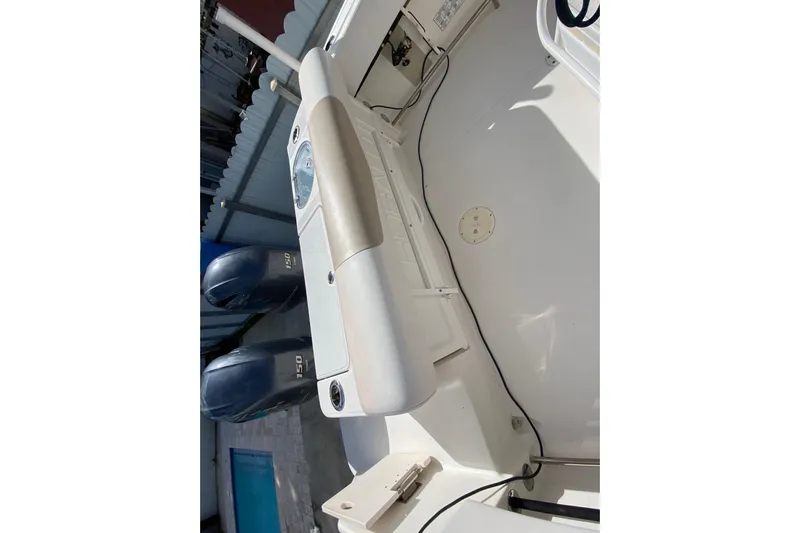  Yacht Photos Pics 2018 Robalo R242 Center Console boat interior with dual engines, white deck, and storage compartments.
