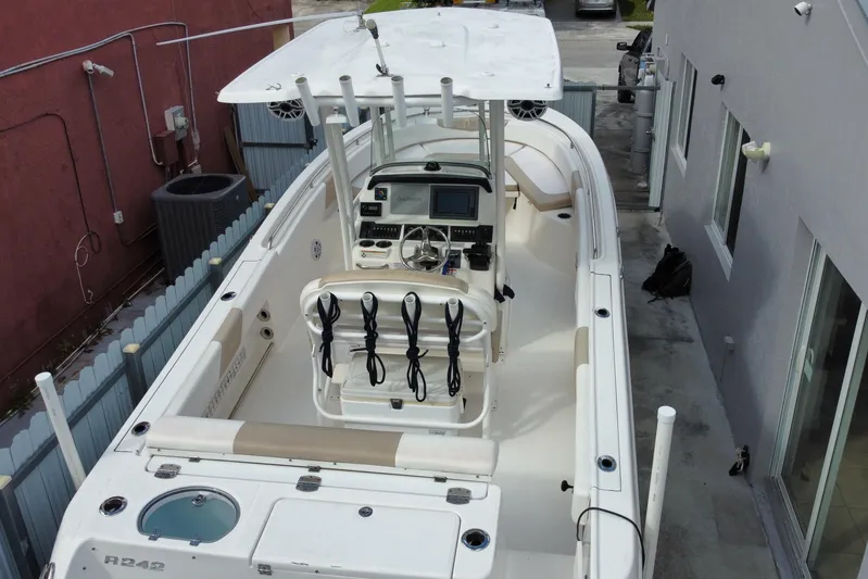  Yacht Photos Pics 2018 Robalo R242 Center Console boat docked in a narrow driveway.