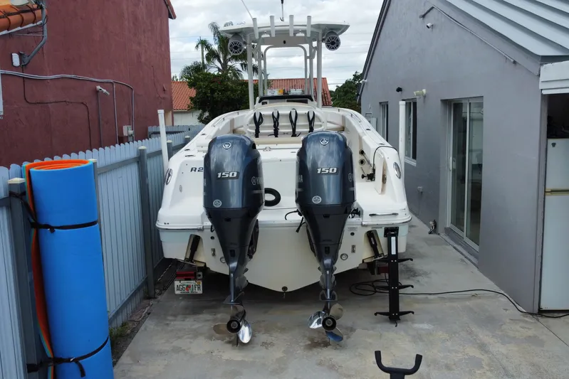  Yacht Photos Pics 2018 Robalo R242 Center Console boat with dual Yamaha 150 engines parked in driveway.
