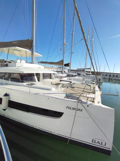 Amura Yacht Photos Pics Bali 5.4 catamaran docked at marina, 2021 model, clear blue sky.