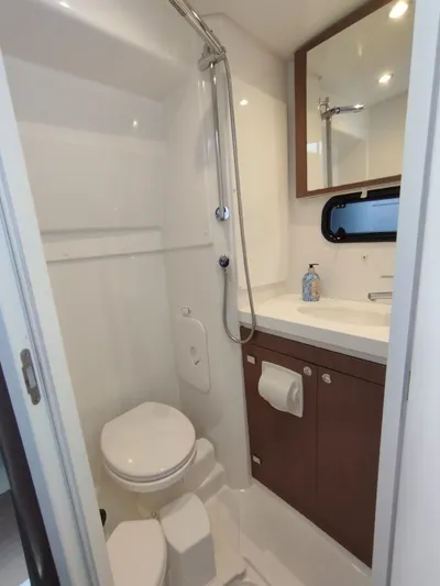 Amura Yacht Photos Pics Compact bathroom in 2021 Bali 5.4 yacht with shower, toilet, and sink.