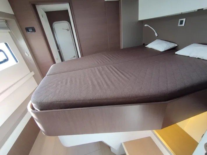 Amura Yacht Photos Pics Modern bedroom interior in a 2021 Bali 5.4 yacht, featuring a cozy double bed.