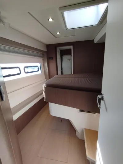 Amura Yacht Photos Pics Interior of a 2021 Bali 5.4 yacht cabin with bed and skylight.
